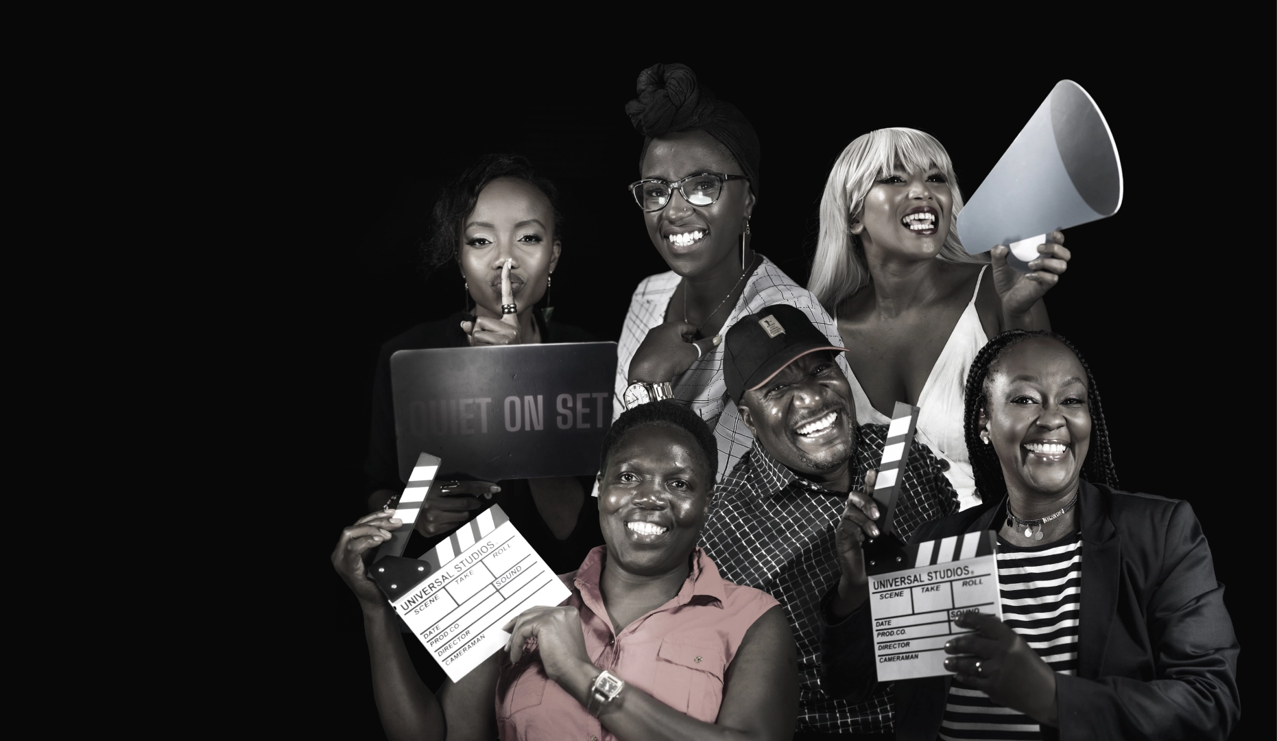 Six members of the Docubox team with clapperboards, a laptop reading Quiet On Set, and a megaphone